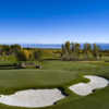 A view of a green and the practice putting green surrounded by bunkers at Cornerstone Club.