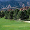 A view of a green with mountains in background from Kissing Camels Golf Club at Garden of the Gods Resort & Club.