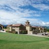 A view of the practice green with clubhouse in background from The Club at Flying Horse