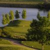 A view of the 16th hole surrounded by water at Bear Creek Golf Club