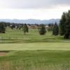 A view of a green protected by bunkers with the driving range in background at Pagosa Springs Golf Club