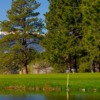 A view over the water of a hole at The Country Club at Woodmoor