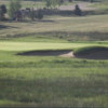 View of a green and bunker at King's Deer Golf Club