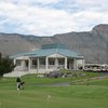 A view of the putting green with clubhouse in background at Battlement Mesa Golf Club
