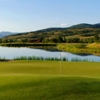 A view of a green with a pond in background at Catamount Ranch and Club.