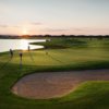 A sunny day view of a green at Pelican Lakes Golf and Country Club.