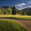 A sunny day view of a green at Aspen Golf Course.